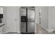 Stainless steel refrigerator in kitchen with tile flooring and white doors and trim at 150 Pleasant Grove Ln, Mooresville, NC 28115