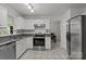 Well-lit kitchen featuring stainless steel appliances, gray countertops, and white cabinets at 150 Pleasant Grove Ln, Mooresville, NC 28115