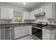Bright kitchen features white cabinets, granite countertops, stainless steel appliances, and subway tile backsplash at 150 Pleasant Grove Ln, Mooresville, NC 28115