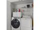 Laundry room with white washer and dryer and storage shelves at 150 Pleasant Grove Ln, Mooresville, NC 28115