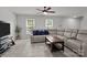 Cozy living room with a large sectional sofa, tiled floors, and a ceiling fan for added comfort at 150 Pleasant Grove Ln, Mooresville, NC 28115
