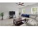 Bright living room featuring neutral tones, tiled floors, and a ceiling fan for added comfort at 150 Pleasant Grove Ln, Mooresville, NC 28115
