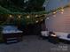 Backyard features a cozy hot tub, comfortable seating around a fire pit and ambient string lights at 1517 Waverly Ave, Charlotte, NC 28203
