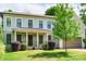 Charming two-story home featuring light gray siding, black trim, a welcoming front porch and well manicured landscaping at 1517 Waverly Ave, Charlotte, NC 28203