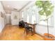 Hallway filled with natural light featuring hardwood floors, a piano, and cozy seating area at 1517 Waverly Ave, Charlotte, NC 28203