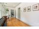 Bright hallway features hardwood floors, white walls, and picture frame molding with access to living room and office space at 1517 Waverly Ave, Charlotte, NC 28203