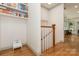 Hallway with charming built-in shelves, complemented by hardwood flooring and a classic staircase at 1517 Waverly Ave, Charlotte, NC 28203