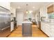 Beautiful kitchen featuring stainless steel appliances, granite countertops, an island, and hardwood flooring at 1517 Waverly Ave, Charlotte, NC 28203