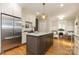 Beautiful kitchen featuring stainless steel appliances, granite countertops, an island, and hardwood flooring at 1517 Waverly Ave, Charlotte, NC 28203