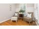 Cozy sitting area featuring stylish chairs, natural light, and hardwood flooring perfect for relaxing at 1517 Waverly Ave, Charlotte, NC 28203