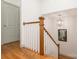 Staircase with wood treads and railings, decorative lighting, and painted walls at 1517 Waverly Ave, Charlotte, NC 28203