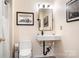 Contemporary half bathroom with floating sink, framed mirror, and custom decor at 15746 Marvin Rd, Charlotte, NC 28277