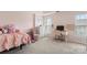 Cozy pink bedroom with a desk and chair area plus lots of room to relax at 15746 Marvin Rd, Charlotte, NC 28277