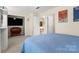 Comfortable bedroom features soft carpet, built-in TV console, and great closet space at 15746 Marvin Rd, Charlotte, NC 28277