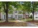 Front view of townhomes with lovely landscaping and coordinated color scheme at 15746 Marvin Rd, Charlotte, NC 28277