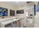 Bright hallway features shelves and lovely artwork, leading to a sunny bedroom at 15746 Marvin Rd, Charlotte, NC 28277