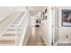 Spacious hallway with hardwood floors, white staircase, and natural lighting throughout at 15746 Marvin Rd, Charlotte, NC 28277