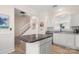 Bright kitchen with stainless steel appliances, granite countertops, and an island, complemented by a classic white staircase at 15746 Marvin Rd, Charlotte, NC 28277