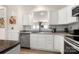Bright kitchen featuring stainless steel appliances, white cabinetry and subway tile backsplash, illuminated by natural light at 15746 Marvin Rd, Charlotte, NC 28277