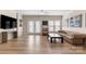 Spacious living room featuring a TV, hardwood floors and French doors at 15746 Marvin Rd, Charlotte, NC 28277