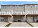 View of the rear of the townhomes with decks and driveways for parking at 15746 Marvin Rd, Charlotte, NC 28277