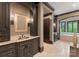 Luxurious bathroom featuring custom dark wood cabinetry, a vessel sink, and a spa-like soaking tub at 172 Tennessee Cir, Mooresville, NC 28117