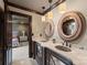 The bathroom features a granite countertop, dual sinks, framed mirrors, and doorway view to the bedroom at 172 Tennessee Cir, Mooresville, NC 28117
