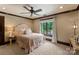 Neutral bedroom with a decorative ceiling fan, plush carpet, and large window with wooded view at 172 Tennessee Cir, Mooresville, NC 28117