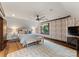 Cozy bedroom featuring a sloped ceiling, a ceiling fan, and a large window offering plenty of natural light at 172 Tennessee Cir, Mooresville, NC 28117