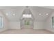 Bright bonus room featuring a window and an ornate chandelier, perfect for various activities and relaxation at 172 Tennessee Cir, Mooresville, NC 28117