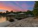 Tranquil lakefront view with two docks, featuring covered seating areas and serene surroundings at 172 Tennessee Cir, Mooresville, NC 28117