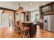 Stunning kitchen with dark wood cabinetry, a large island, and stainless steel appliances, ready for culinary adventures at 172 Tennessee Cir, Mooresville, NC 28117