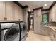 Well-equipped laundry room featuring modern appliances and custom cabinetry, designed for convenience at 172 Tennessee Cir, Mooresville, NC 28117