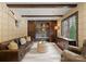 Inviting living room featuring a comfortable leather sofa, rustic wood beams, and stylish decor at 172 Tennessee Cir, Mooresville, NC 28117
