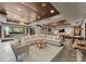 A large living room with an oversized couch, area rug, and adjacent bar and game room at 172 Tennessee Cir, Mooresville, NC 28117