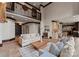 Spacious living room with a balcony, hardwood floors, and comfortable seating arrangements at 172 Tennessee Cir, Mooresville, NC 28117