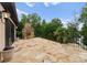 Spacious outdoor patio with a stone fireplace, scenic views, and lush landscaping at 172 Tennessee Cir, Mooresville, NC 28117