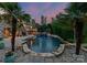 Resort-style pool with stone coping, rock features, and palm trees, showcasing a luxury outdoor oasis at 172 Tennessee Cir, Mooresville, NC 28117