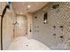 Luxurious walk-in shower featuring multiple shower heads and mosaic tile, creating a spa-like experience at 172 Tennessee Cir, Mooresville, NC 28117