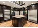 Spacious walk-in closet with an island, custom shelving, and ample storage space with a skylight at 172 Tennessee Cir, Mooresville, NC 28117