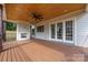 Cozy covered deck with fireplace and ceiling fan at 1817 Union St, Charlotte, NC 28205