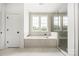 Luxurious bathroom featuring a soaking tub, glass shower, and serene natural light at 1817 Union St, Charlotte, NC 28205