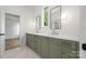 Bathroom with dual sinks, quartz countertops, and elegant olive cabinetry at 1817 Union St, Charlotte, NC 28205