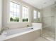 Bright bathroom with a soaking tub, glass shower, and natural light at 1817 Union St, Charlotte, NC 28205