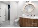 Stylish bathroom featuring a wood vanity, modern fixtures, and decorative round mirror at 1817 Union St, Charlotte, NC 28205