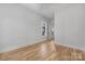 Bedroom featuring hardwood floors, white walls, window, and doorway leading to another room at 1817 Union St, Charlotte, NC 28205