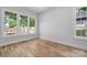 Sunlit bedroom with hardwood floors and large windows overlooking the backyard at 1817 Union St, Charlotte, NC 28205