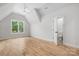 Bright bedroom featuring hardwood floors, white walls, ceiling fan, and large window at 1817 Union St, Charlotte, NC 28205