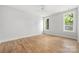 Bright bedroom with hardwood floors, a ceiling fan, and natural light at 1817 Union St, Charlotte, NC 28205