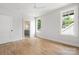 Bright bedroom with hardwood floors and a large window overlooking lush greenery at 1817 Union St, Charlotte, NC 28205